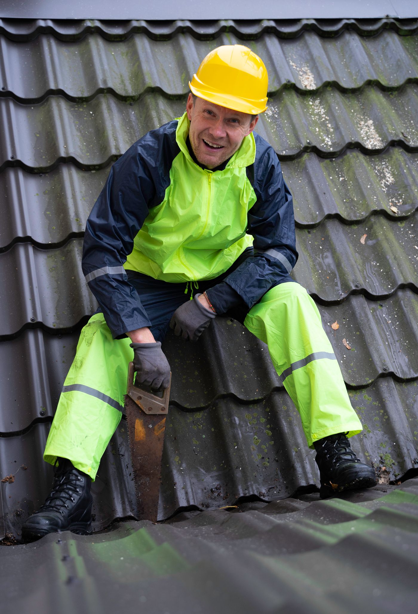 Roofer cutting roof tiles during installation